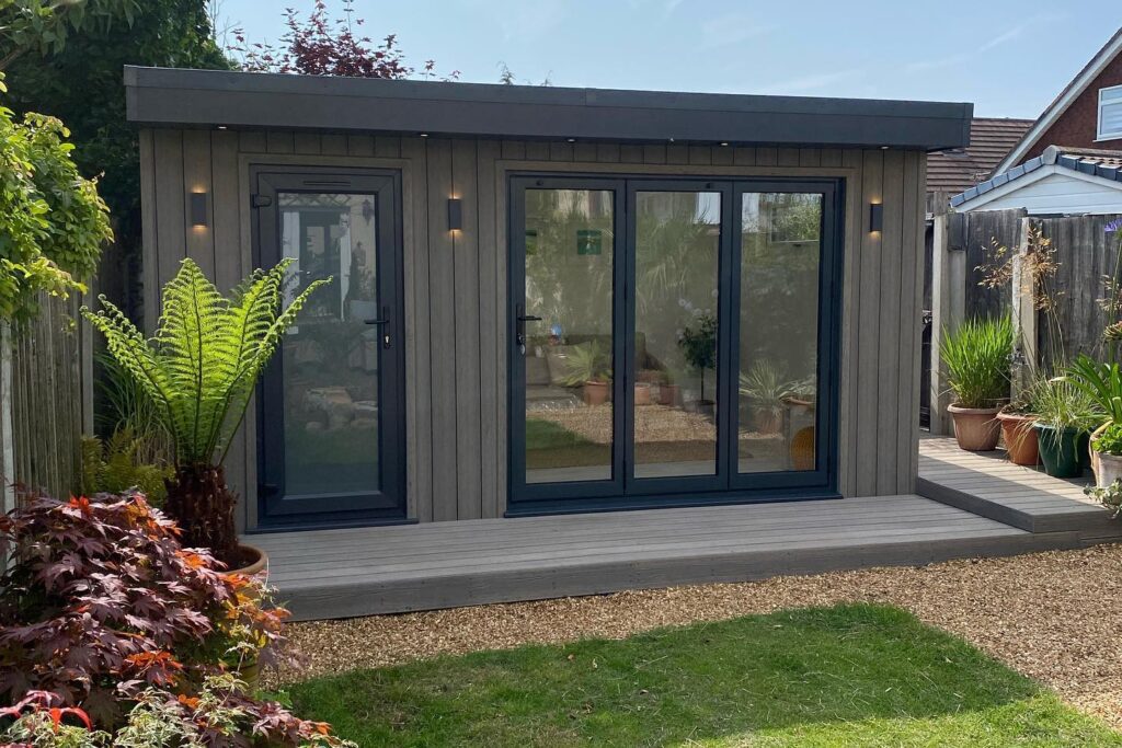 light grey garden room with black bi folding doors.